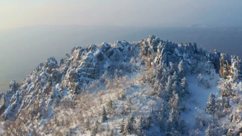 Snow-capped mountain ranges covered with coniferous forest Video stock 159151222