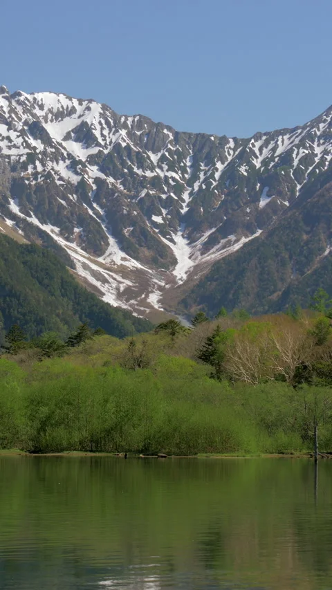 Snow Capped Mountain Reflected in Taisho Pond Vertical Video 動画素材 346002975