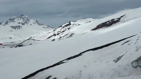 Snow capped mountain summit and cloudscape Stock Footage 136519767