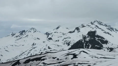Snow capped mountain summit and cloudscape Stock Footage 136520057