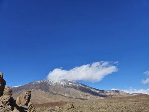 Snow capped mountain under dramatic blue sky Photos