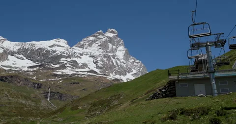 Snow-capped mountain view and ski lift on a sunny day in the breathtaking Alps, 스톡 동영상 314077823