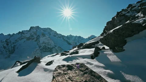 Snow capped mountains above clouds in a blue sky in sunny weather Stock Footage 138037686