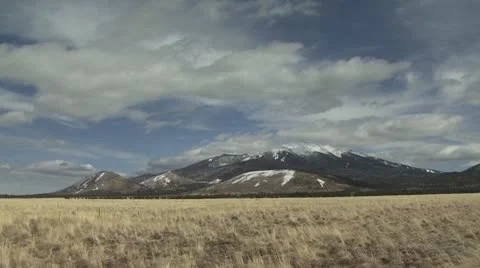 Snow Capped Mountains Against A Cloudy Sky Background Stock-Footage 19012739