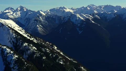Snow capped mountains and evergreen forest landscape Stock Footage 340962627