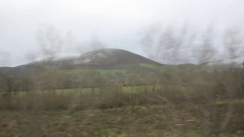 Snow capped mountains and fields from train Stock Footage 76797764
