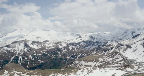Snow-capped mountains and winding roads showcase stunning natural beauty in the 스톡 동영상 314082408