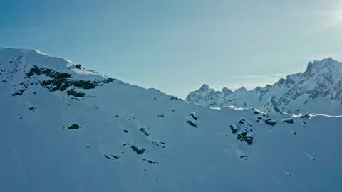 Snow capped mountains on a blue sky in sunny weather, flight, Caucasus mountains Stock Footage 138035225