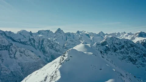 Snow capped mountains on a blue sky in Sunny weather, flight, Caucasus mountains Stock Footage 138035860