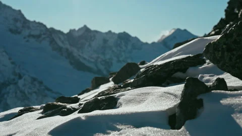 Snow capped mountains on a blue sky in sunny weather Stock Footage 138036176