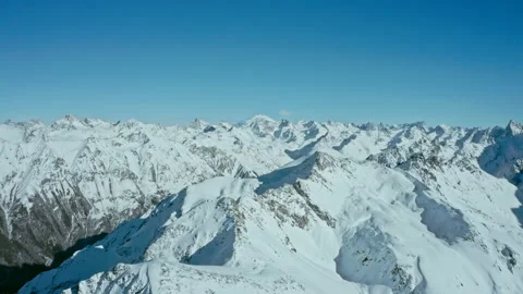 Snow capped mountains on a blue sky in sunny weather, flight, Caucasus mountains Stock Footage 138036851