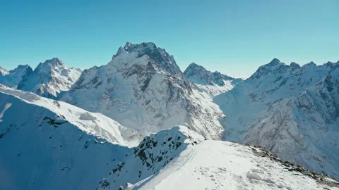 Snow capped mountains on a blue sky in Sunny weather, Caucasus mountains Stock Footage 138037513