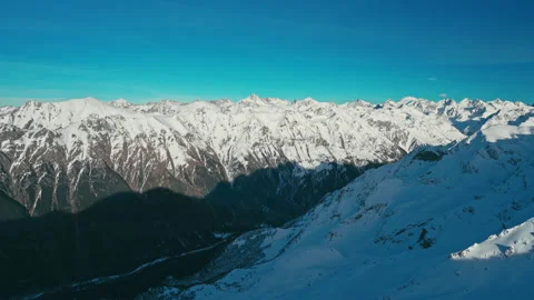 Snow capped mountains on a blue sky in Sunny weather, Caucasus mountains Stock Footage 138038061