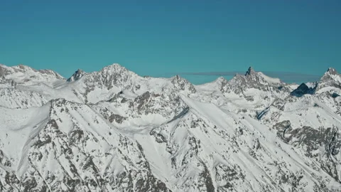 Snow capped mountains on a blue sky in Sunny weather Stock Footage 138039095