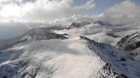 Snow-capped mountains in the clouds, bird's-eye view. Far north, wilderness. Stock Footage 167050056