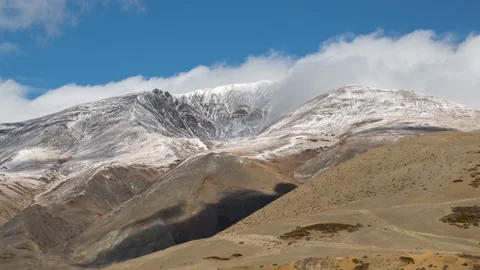 Snow-capped mountains in the clouds. Snow-capped peaks of the mountains in the c 스톡 동영상 199486619