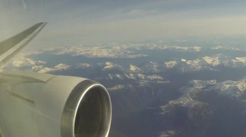 Snow capped mountains from Plane with engine and wing Stock Footage 34145864