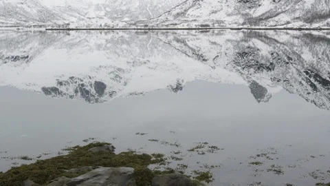 Snow-capped mountains reflecting in the lake in winter Stock Footage 113224079