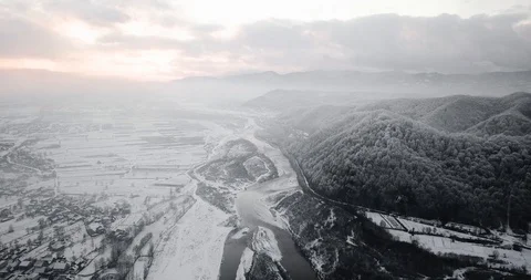 Snow-capped mountains river sunset snowfall drone Stock Footage 122602743