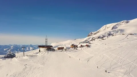Snow-capped mountains, a ski slope with a lift. Elbrus, aerial video shooting Stock Footage 114802737