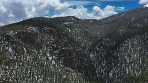 Snow capped mountains stand out against the blue sky in Colorado Stock Footage 247364214