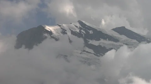 Snow capped mountains surrounded by clouds - Swiss Alps 動画素材 32186627