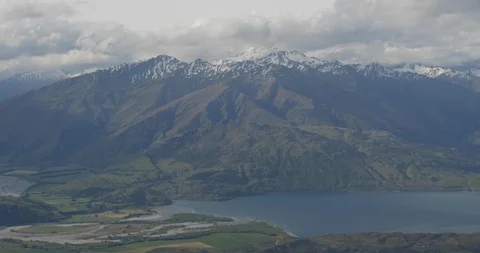 Snow capped mountains tower above Lake Wanaka Stock Footage 119552558