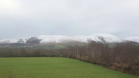 Snow capped mountains from train Stock Footage 76798059