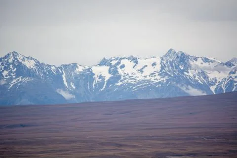 Snow-Capped Mountains Under Cloudy Sky Stock Photos