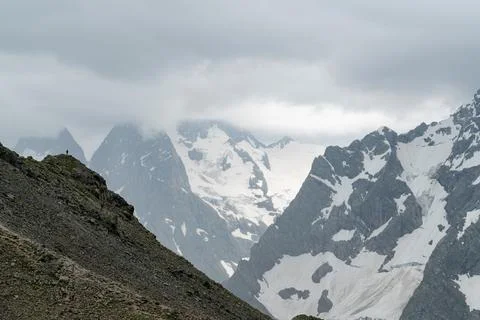 Snow-capped mountains under cloudy sky Stock Photos