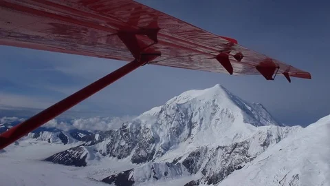 Snow-Capped Mountains under the Wing of a Red Plane Vídeo Stock 84662606