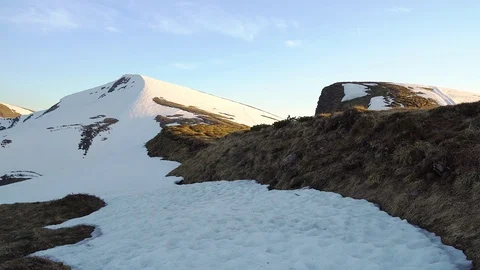 Snow-capped mountainside at sunset Stock Footage 112623175