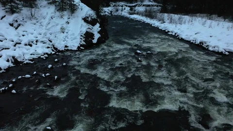 Snow capped rapid river flows Stock Footage 104834308