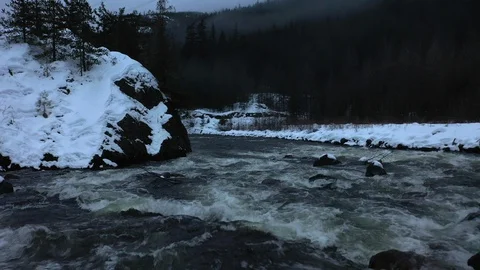 Snow capped rapid river flows Stock Footage 104834850