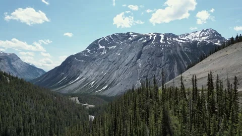 Snow-capped Rocky Mountain range with rugged peaks and alpine wilderness Video stock 327672199