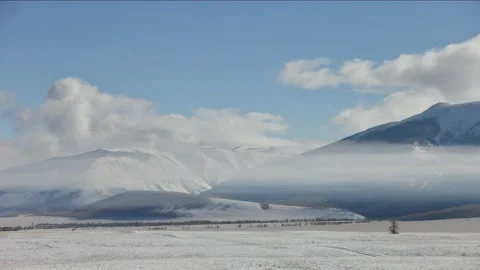 Snow capped steppe and big snowy mountains. Low contrast timelapse Stock Footage 147315895