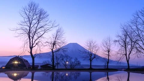 Snow Capped Volcanic Peak Reflection In Calm Reservoir At Twilight Wide Shot Stock Photos