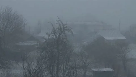 Snow in the city. Heavy snow falling in the city neighbourhood in daytime Stock Footage 236376054