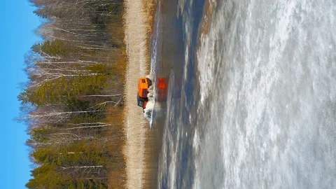 Snow Clad Trail Conqueror. Red ATV Arctic Odyssey. Vertical 9x16 Aerial Drone Stock Footage 263078218