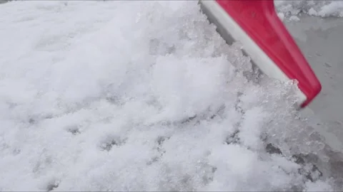 Snow is cleaned of the car with a red scraper Stock Footage 301917798
