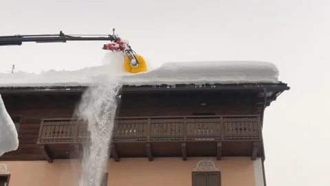 Snow cleaning machine for house roofs Stock Footage 152347292