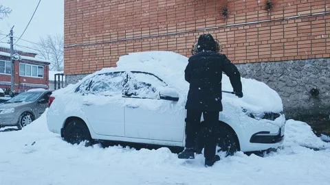 Snow cleaning preparing the car for driving Stock Footage 326499419