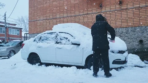 Snow cleaning preparing the car for driving Stock Footage 326499746