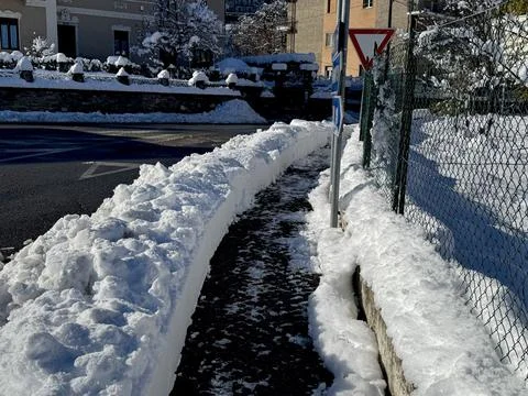 Snow-Cleared Walkway Surrounded by Deep Snow. Stock Photos