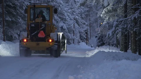 Snow clearing. Tractor clears the way after heavy snowfall in forest Stock Footage 88654170