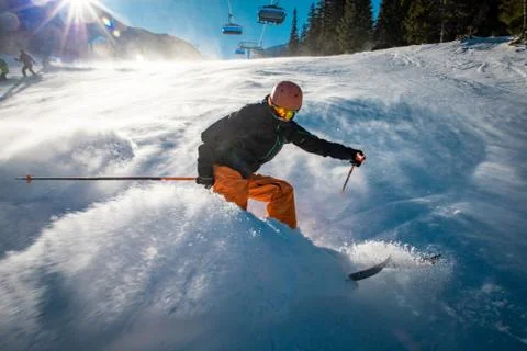 Snow cloud produced by aggressive braking from a young skier Stock Photos
