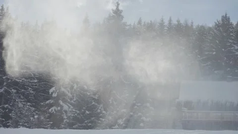 Snow clouds whirl above the pine forest and the rustic cabin covered with snow Stock Footage 310383182