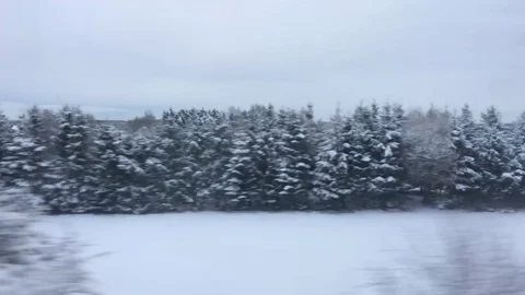 Snow concealed Country Fields pass by a train creating a beautiful Winter Scene 動画素材 84676646