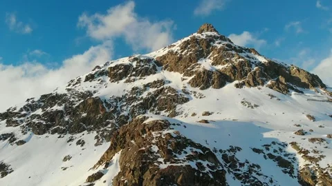 Snow-Covered Alpine Mountain Peak Under Clear Blue Sky Stock Footage 341608402