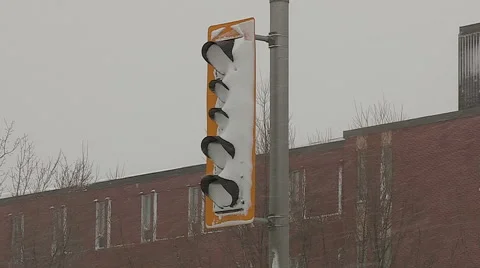 Snow covered and dangerous LED cool traffic lights in snowstorm Stock Footage 56507461